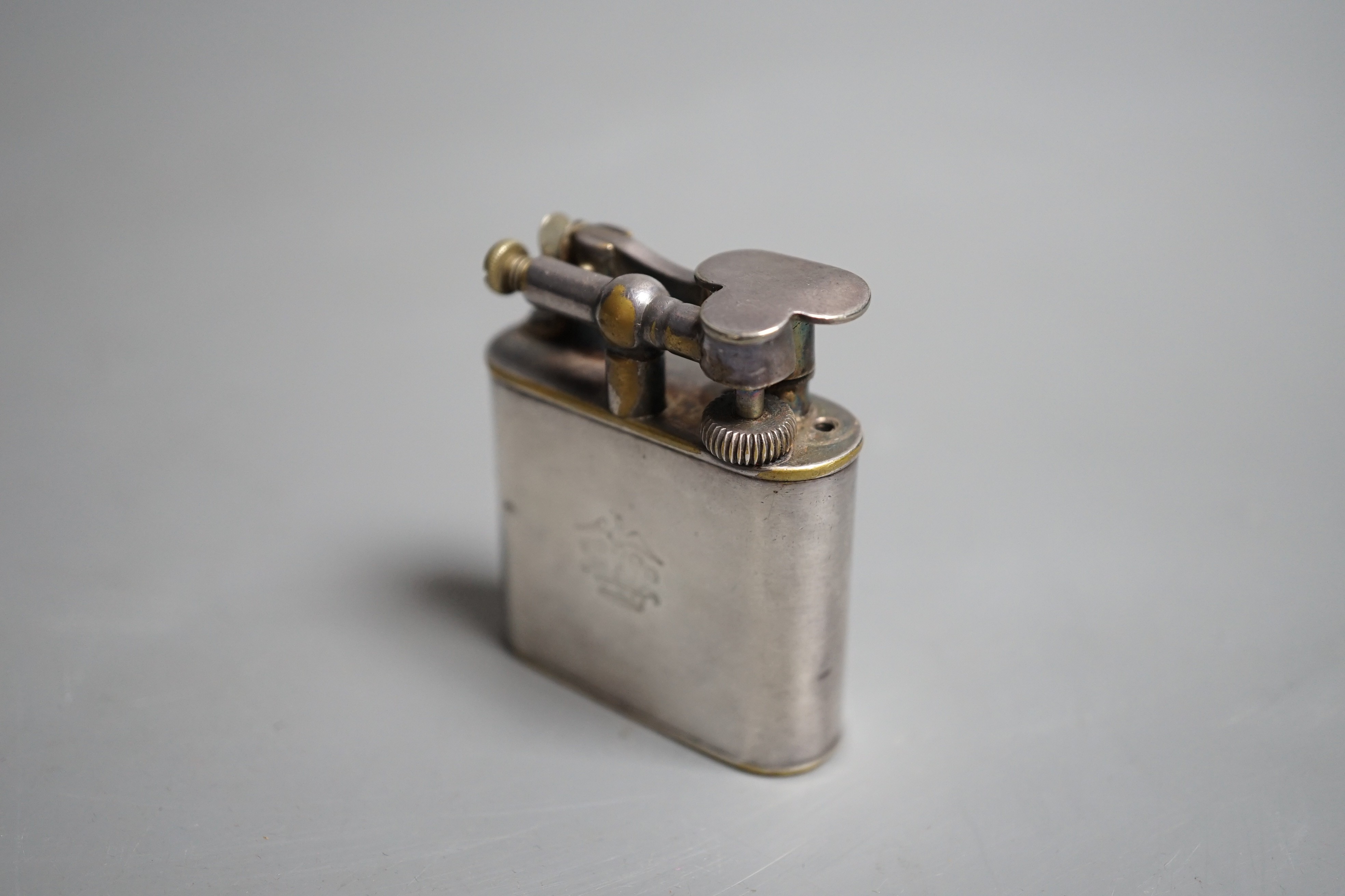A vintage 1930’s Dunhill Unique Sports plated nickel cigarette lighter.